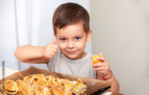 happy little boy eats pie