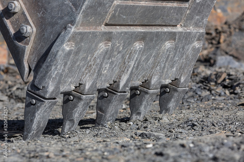 The teeth of the excavator bucket. Construction equipment.