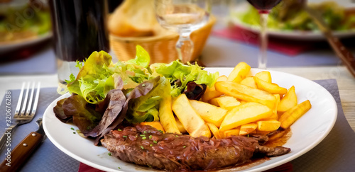 Flank steak with shallots red wine sauce and French fries. 