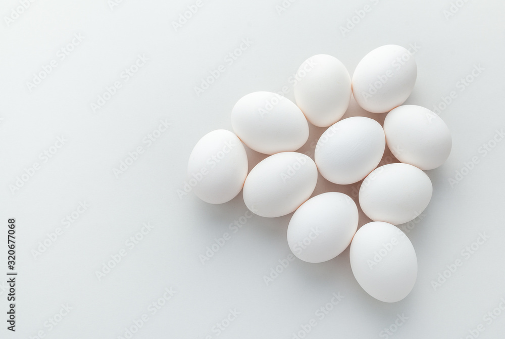 group of white chicken eggs on a gray background