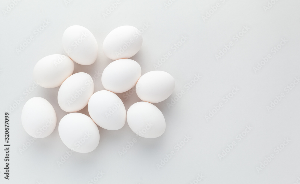 white chicken eggs on a gray background