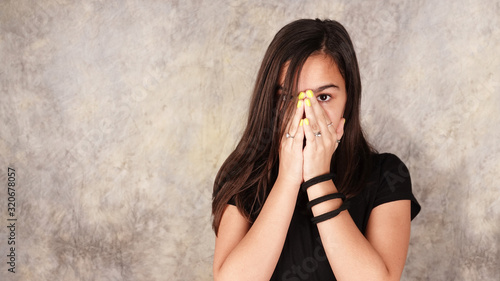 Konstfotografi Girl is touching her face with hands and looking through