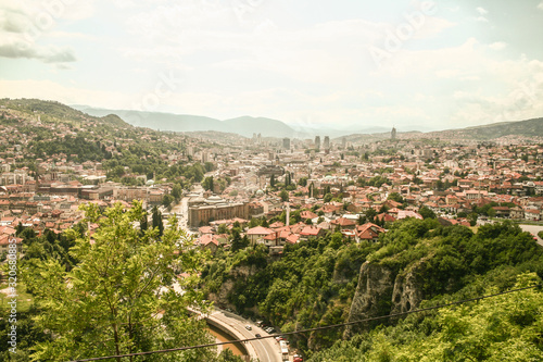 Panorama of the city center of Sarajevo, Bosnia and Herzegovina, seen from above. The major landmarks of the old towns, such as mosques, and skyscrapers are visible, during a sunny afternoon