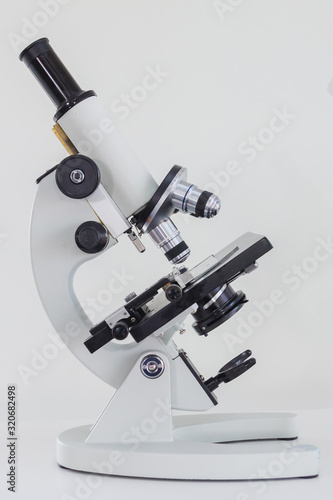 microscope with high magnification lens with black plate with white background