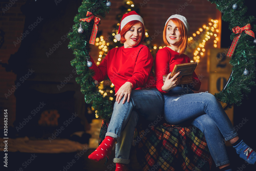 Elegant mother in a red sweater. Adult woman with her daughter