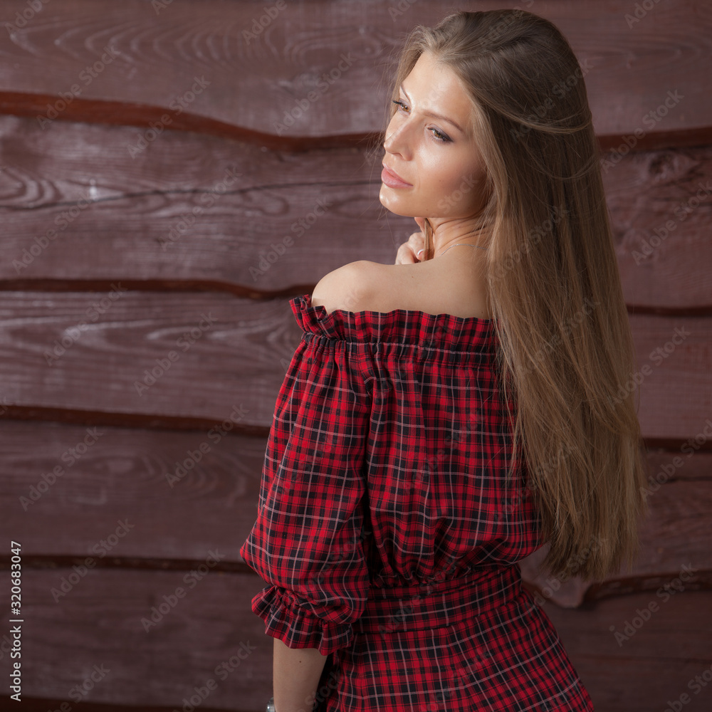Fototapeta premium Portrait of beautiful young girl on wooden background.