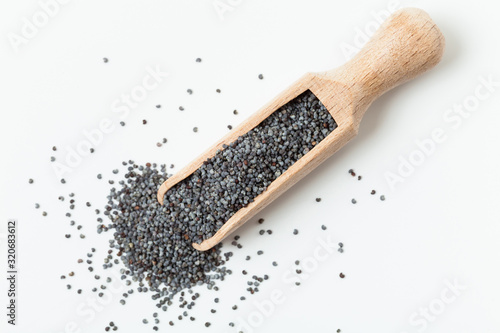 Wooden scoop with poppy seeds. Empty space. Top view.