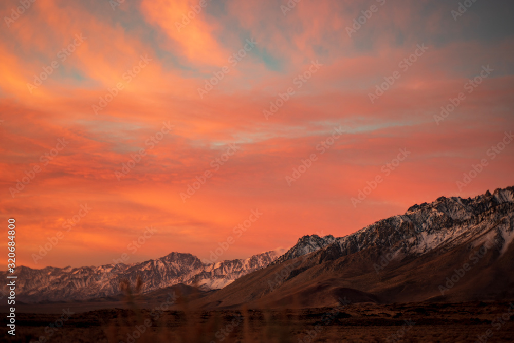 first morning sunlight illuminates snowy mountain peaks in California