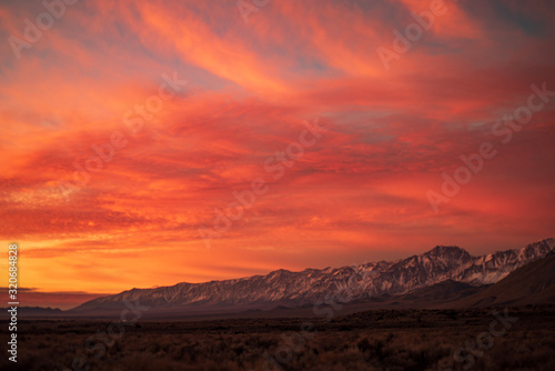 Fototapeta Naklejka Na Ścianę i Meble -  first morning sunlight illuminates snowy mountain peaks in California