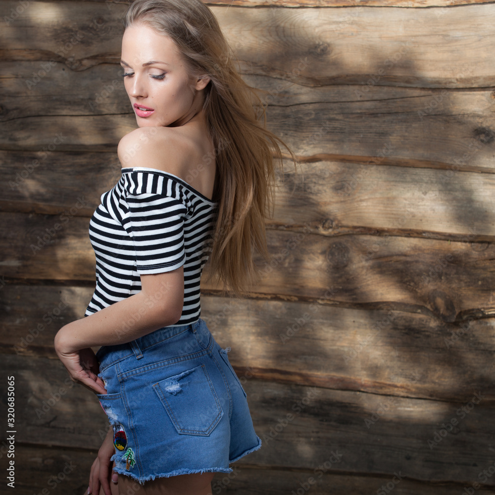 Portrait of beautiful young girl on wooden background. Portrait of beautiful young girl on wooden background.