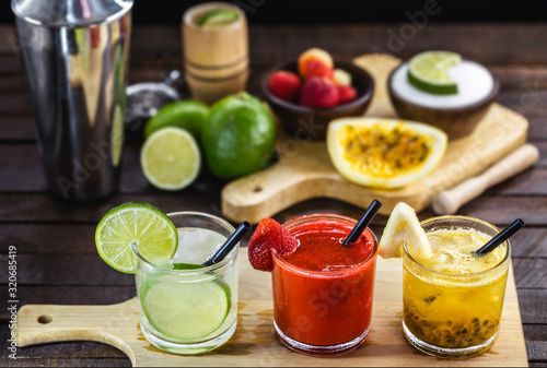 Brazilian caipirinha, typical Brazilian cocktail made with fruits. Lemon, strawberry and passion fruit, cachaça or vodka with sugar. Cultural and gastronomic heritage of Rio de Janeiro. photo