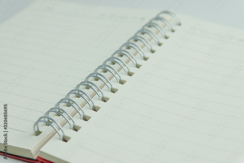 The notebook has lines placed on a white scene. The notebook has lines placed on a white scene.