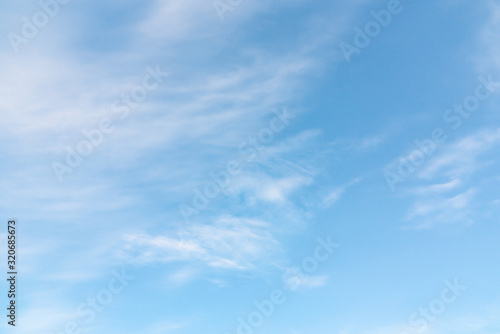 Light cirrus clouds in the blue sky on a sunny day, full frame image, background © Галина Сандалова