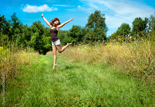 Woman jumping on nature walkway