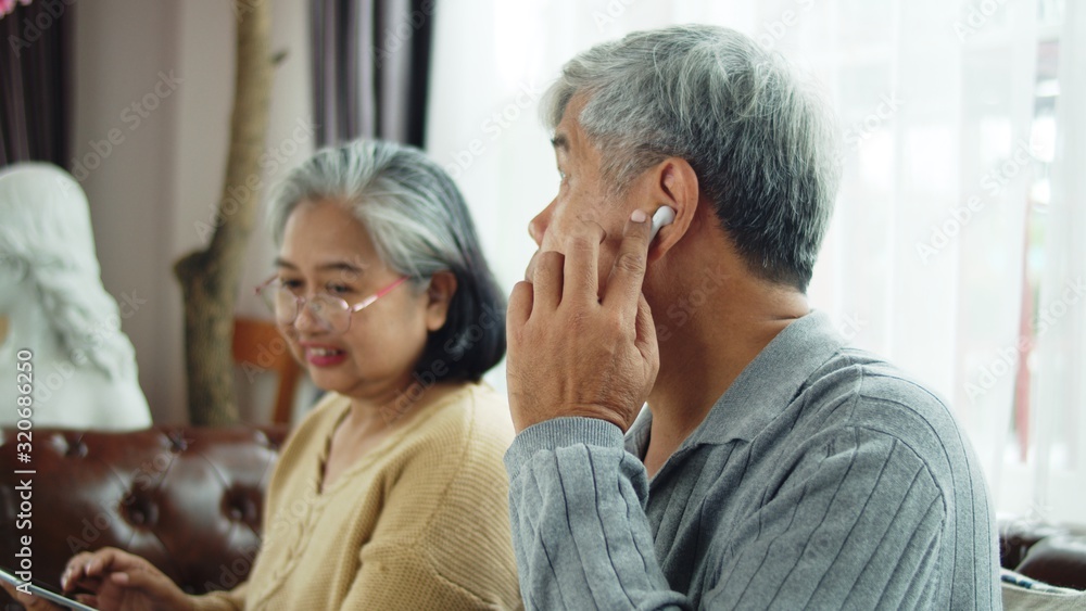 Senior man use wireless earphone to talking with telephone communication Senior man use wireless earphone to talking with telephone communication