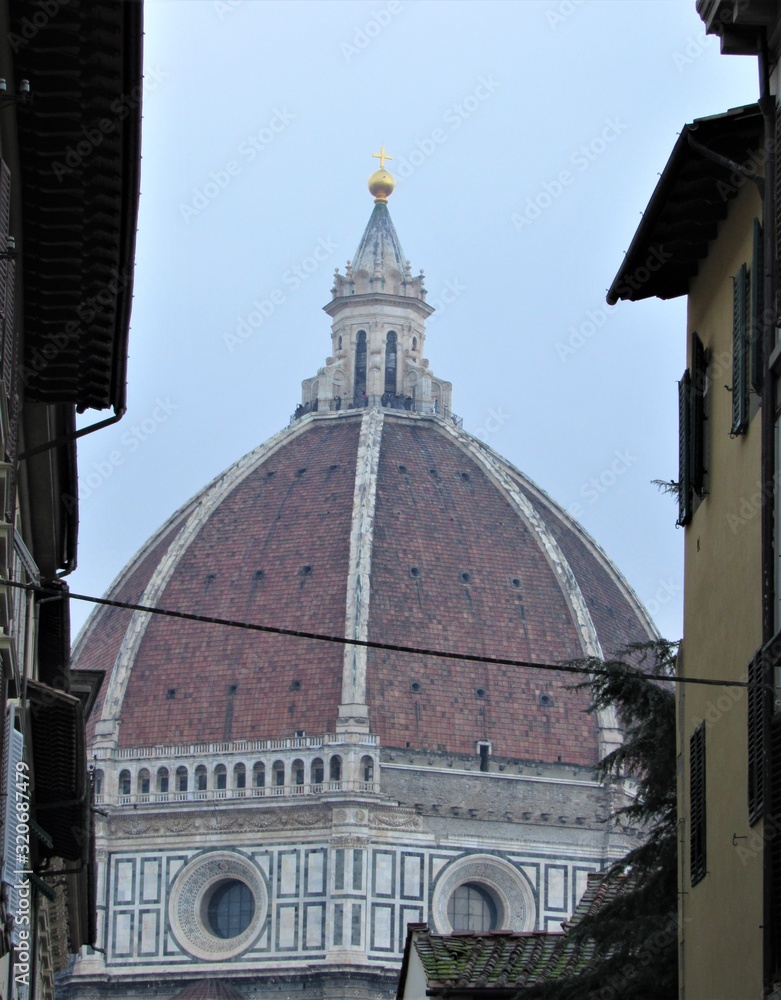 View between buildings of Florence Cathedral, or the Cathedral of Santa Maria del Fiore in Italy 
