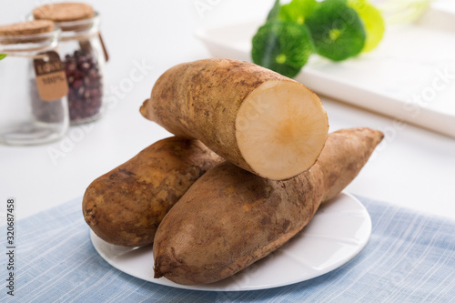 Smallanthus sonchifolius on the white plate, he in the white background, is a nutritional health of the wild plant fruit, pharyngeal inhibition