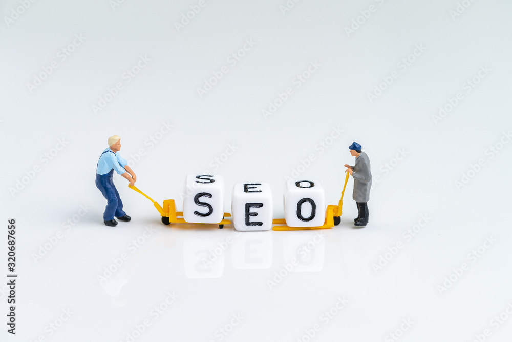 Miniature people man pulling forklift with cube small block building the word SEO on solid white background using as Search Engine Optimization, website search result advertising concept Miniature people man pulling forklift with cube small block building the word SEO on solid white background using as Search Engine Optimization, website search result advertising concept