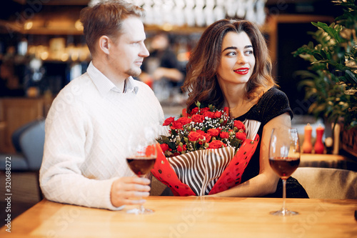 Couple in a restaurant. Lady in a black dress