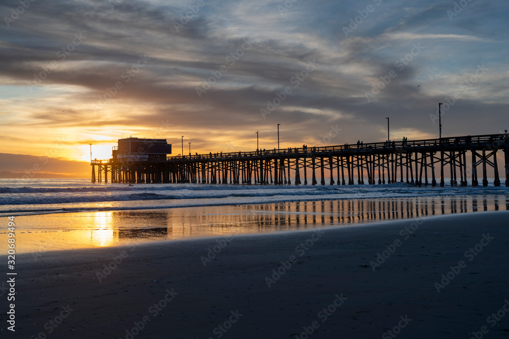 The Newport Beach Pier framed by a beautiful Pacific Sunset The Newport Beach Pier framed by a beautiful Pacific Sunset