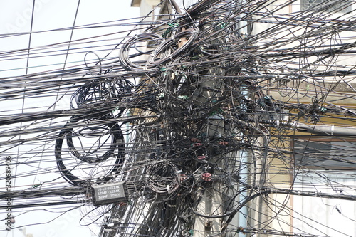 Photography Chaos of cables and wires on an electric pole.