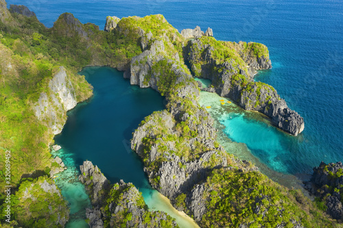Fototapeta Naklejka Na Ścianę i Meble -  View from above, aerial view of the Big Lagoon and the Small Lagoon, two beautiful bays of crystal clear water surrounded by rocky cliffs. Miniloc Island, Bacuit Bay, El Nido, Palawan, Philippines.