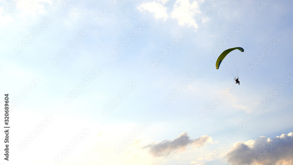 Paraglider flying against sky over Khao Jeen Lae mountain in Lopburi, Thailand Paraglider flying against sky over Khao Jeen Lae mountain in Lopburi, Thailand