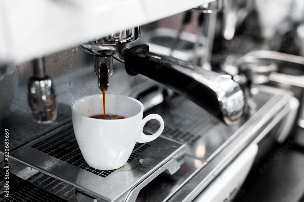 black coffee in white cup on coffee maker black coffee in white cup on coffee maker