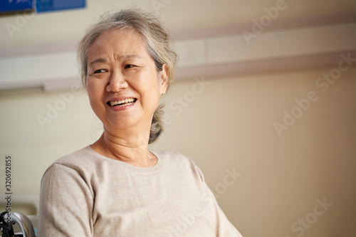 Obraz na plátně portrait of an asian senior woman looking away smiling
