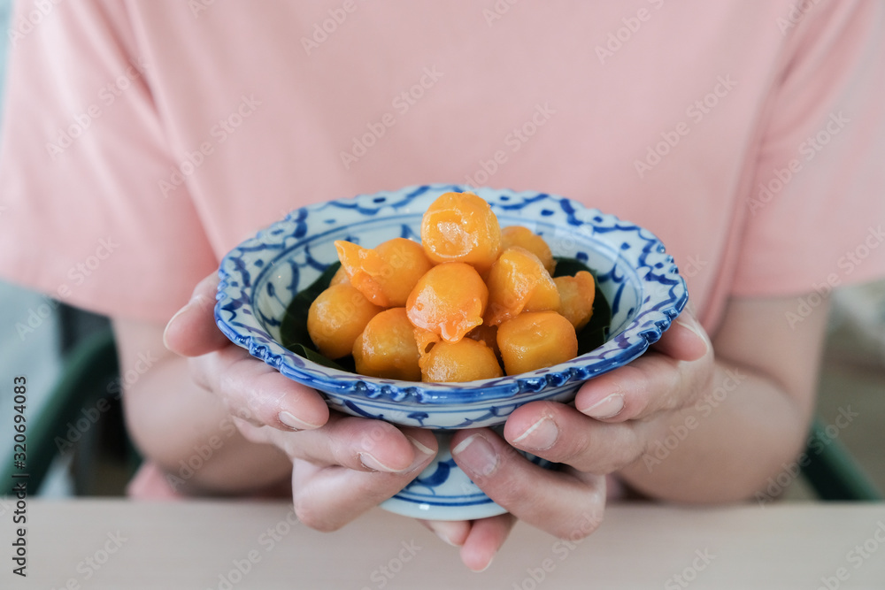 Cropped shot view of woman holding Thai dessert named Cropped shot view of woman holding Thai dessert named