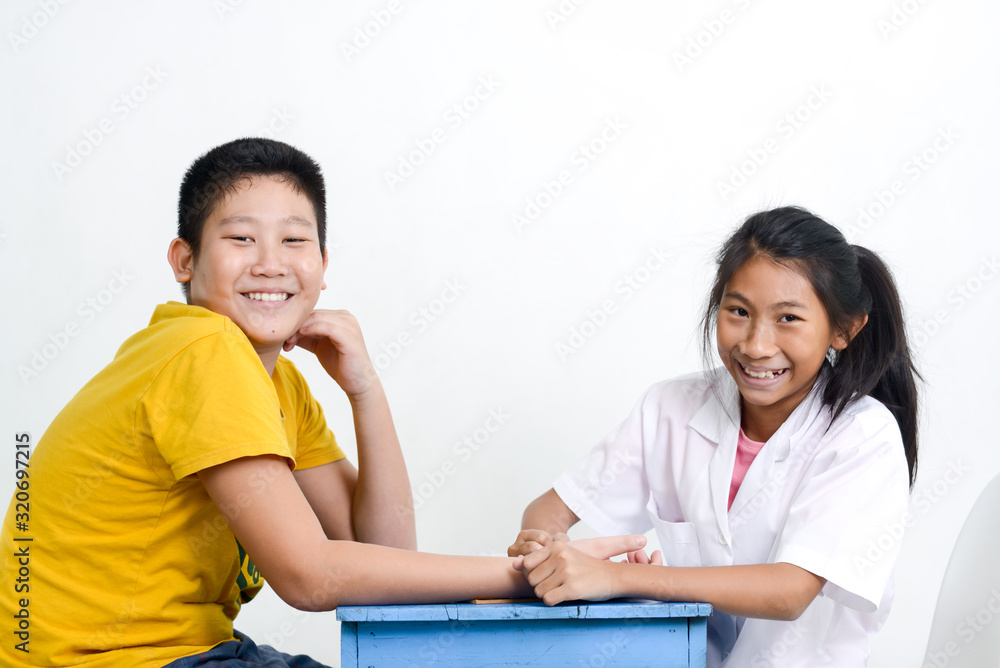 Asian children playing doctor at home, girl doctor checking up her patient. Asian children playing doctor at home, girl doctor checking up her patient.