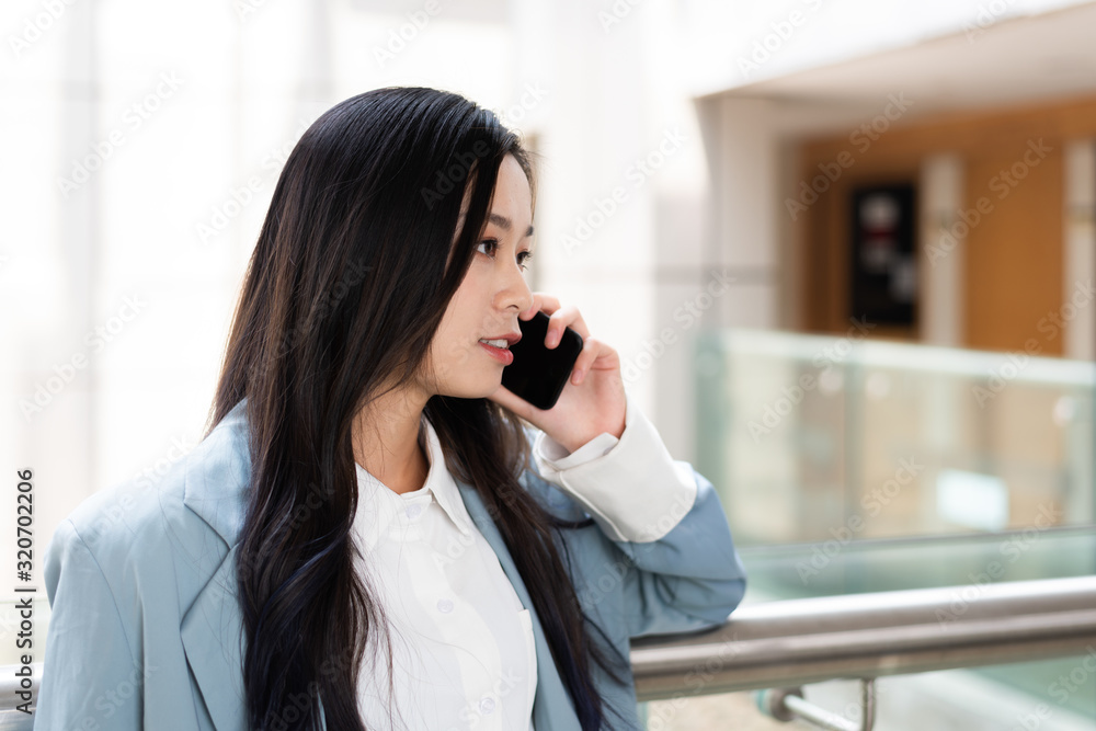 Young business lady calls in the corridor of the office building Young business lady calls in the corridor of the office building