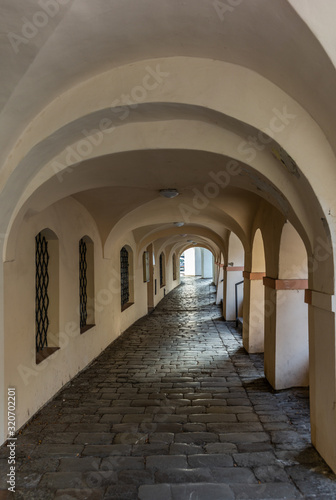 An empty covered arched walk in Prague