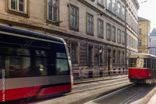 Modern and old trams in Prague moving during a sunny day