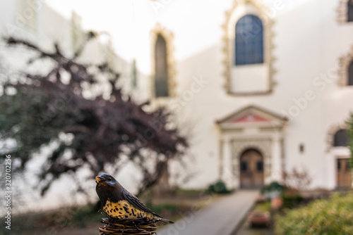 Detail of a bird scultpure in the  coutyard outside the Church of the Maltese Order in Prague photo