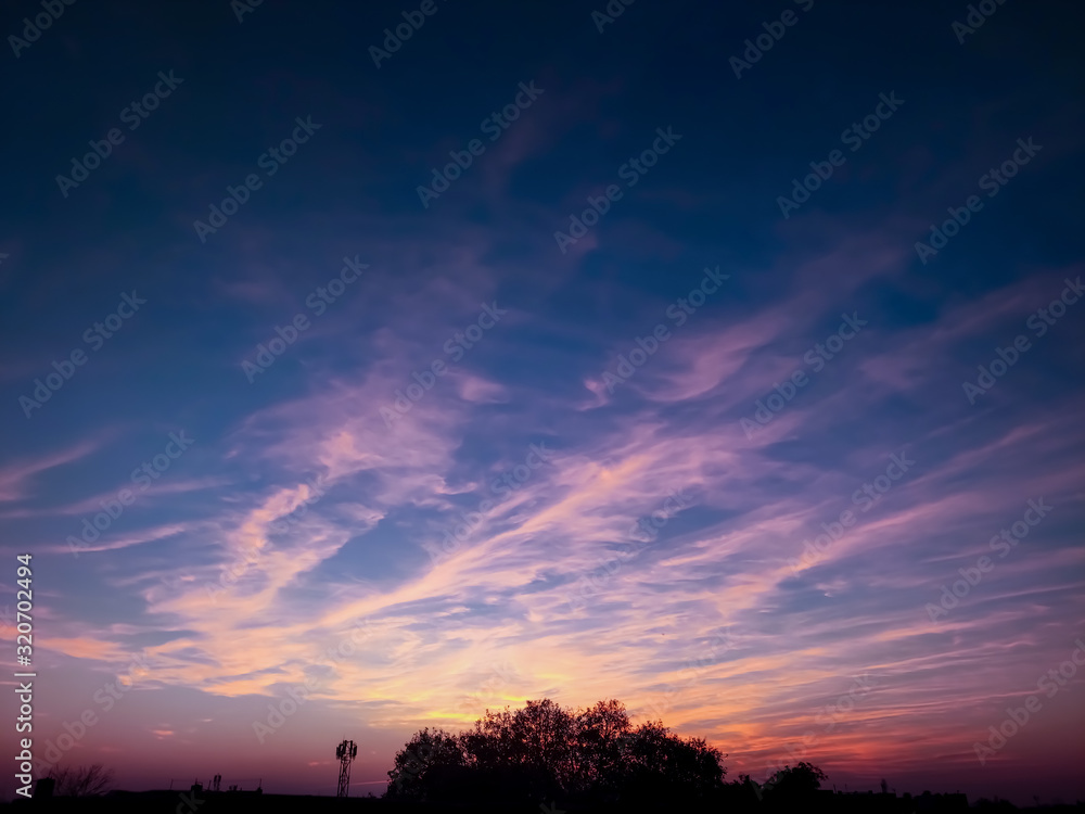 Fototapeta premium sunset in the sky with blue and pink sun lightning