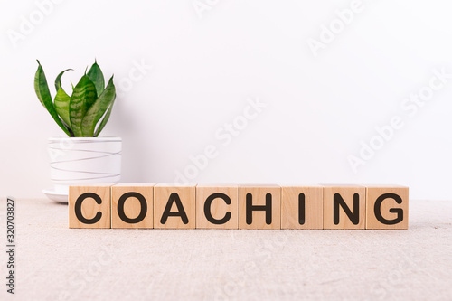 Photographie COACHING word made with building blocks on a light background