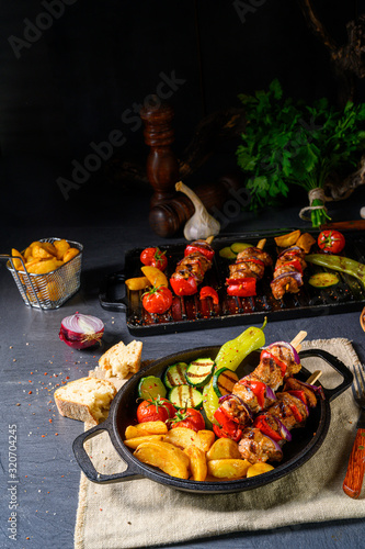 Shish kebab with various vegetables and spice country potatoes