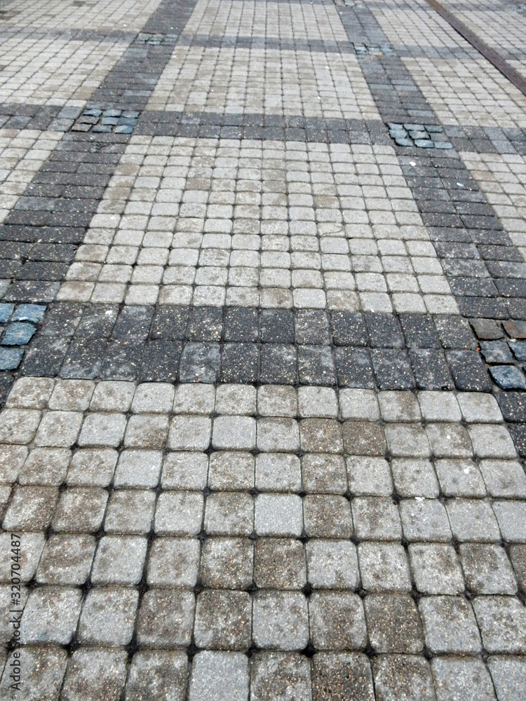 wet track paved with gray curly tiles