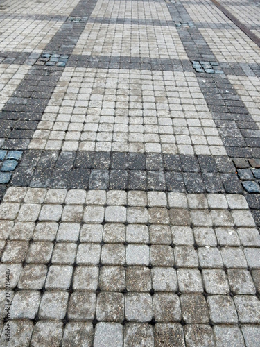 wet track paved with gray curly tiles