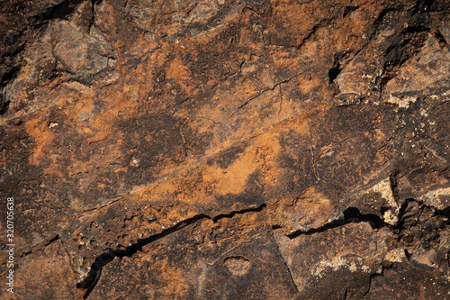 close up of brown and orange rust like stone formation texture background