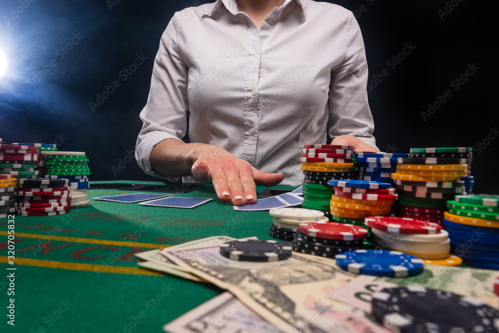 Gambling and gaming business in a casino. Girl hands out cards. Concept of playing cards. Gambling and gaming business in a casino. Girl hands out cards. Concept of playing cards.