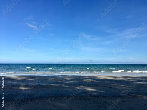Fototapeta Naklejka Na Ścianę i Meble -  Scenery of empty sea beach sand and blue sky on summer sun day