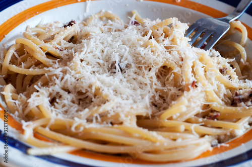 close up of italian spaghetti. Italian pasta with bacon, parmisan cheese and olive oil.   healthy diet photo