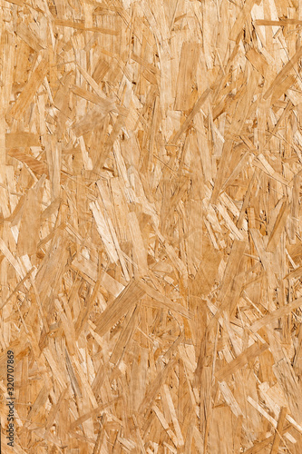 Fototapeta Naklejka Na Ścianę i Meble -  Flat lay surface of a wood chipboard. Vertical wood texture. OSB - oriented strand board. Abstract wooden background.