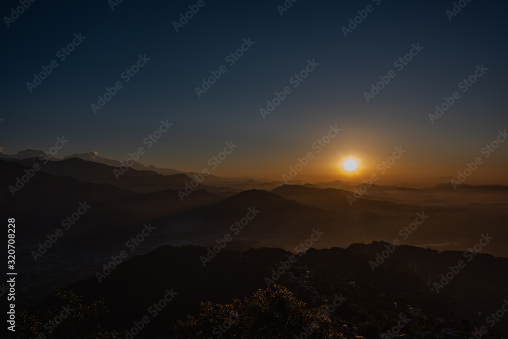 Pokhara sunrise at Sarangkot Hill with view of Himalayan mountain range.