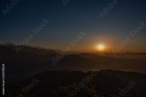 Pokhara sunrise at Sarangkot Hill with view of Himalayan mountain range.