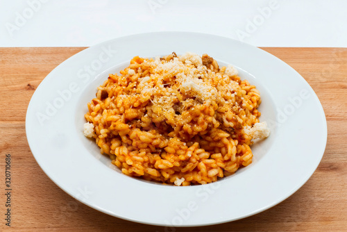 Traditional italian risotto with bolognese ragu and parmigiano reggiano cheese