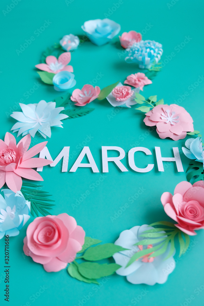 The number 8 is made of flowers cut from paper on a mint background The number 8 is made of flowers cut from paper on a mint background