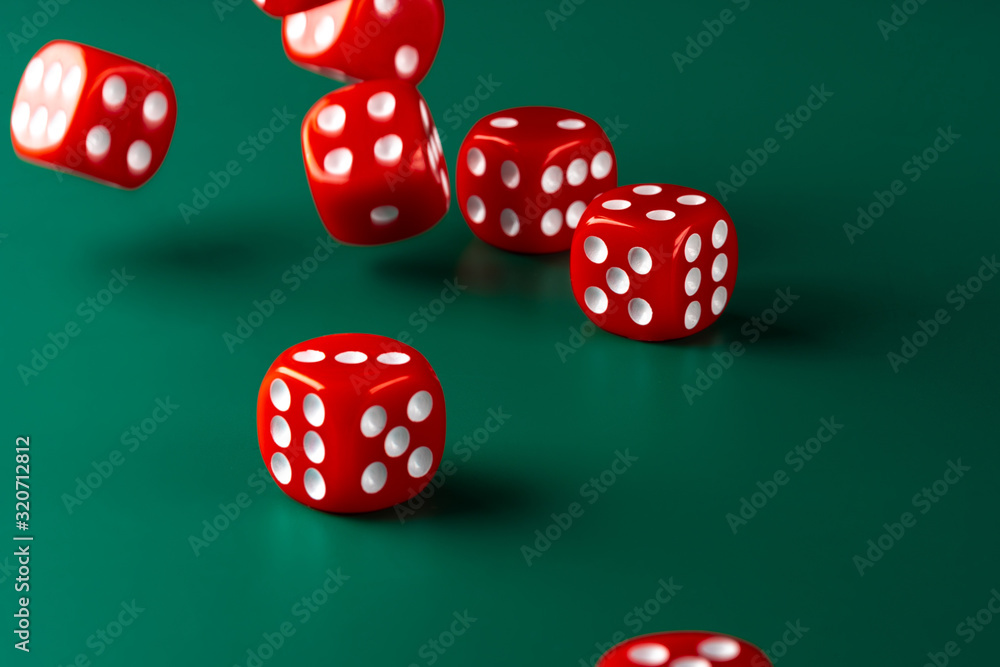Red dice on green background close up Red dice on green background close up